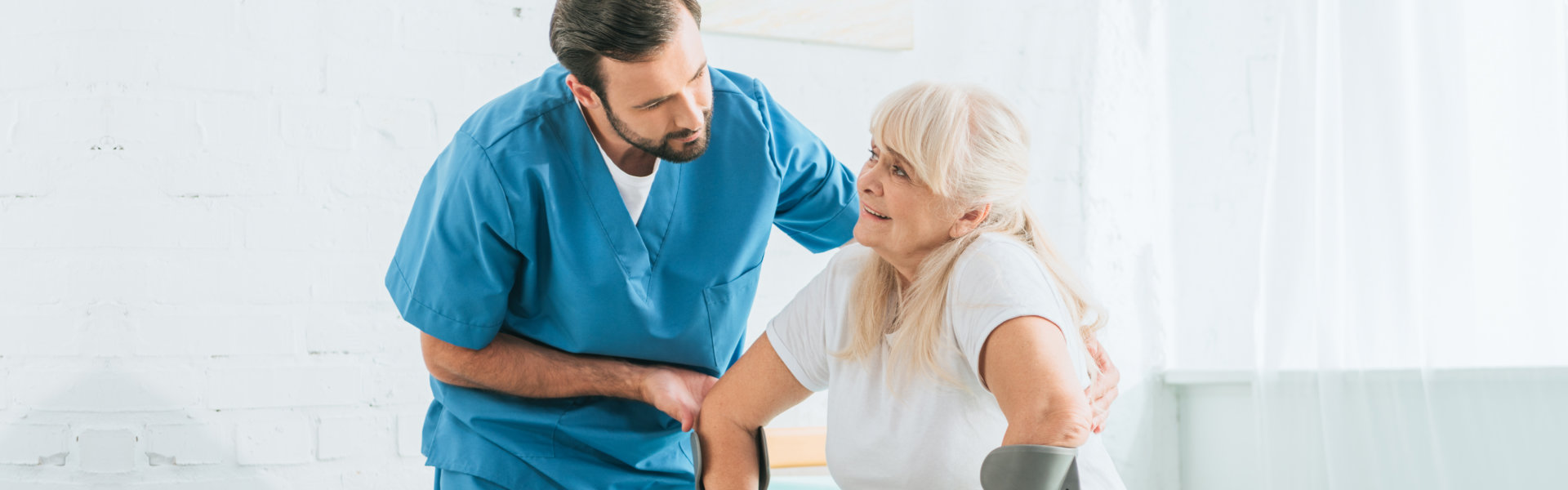 caregiver man assisting a senior woman